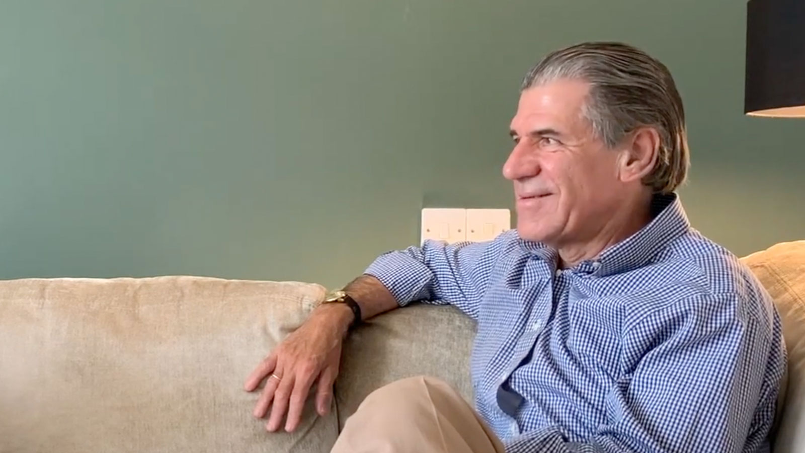 Stephen Seligman Interview screenshot of him sitting on a couch smiling